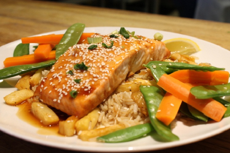 Teriyaki salmon filet with pineapple brown rice, snow peas and carrots from Meal Village Asian food delivery in Chicago.