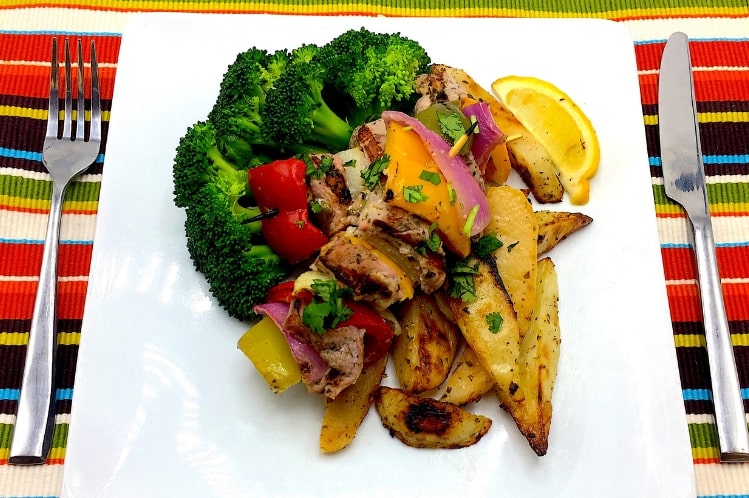 Grilled Greek pork loin skewers with peppers and onions, lemon roasted potatoes and broccoli florets.