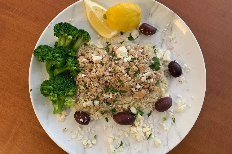 Greek chicken power bowl with ground chicken over white rice, feta cheese, zucchini and yellow squash.