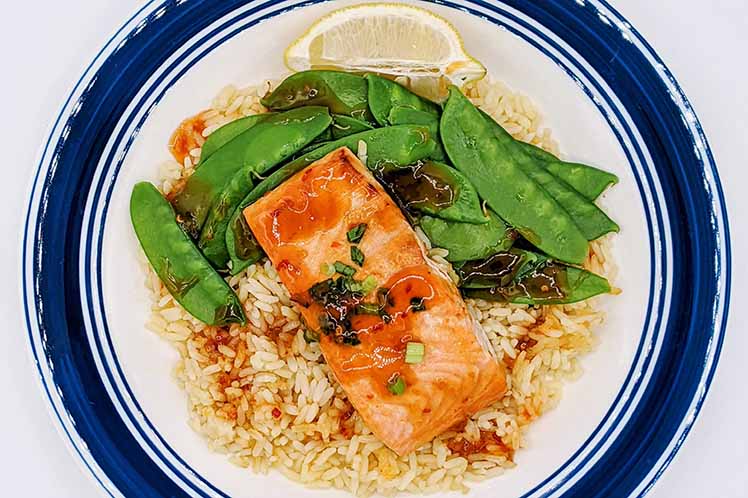 Sweet chili garlic glazed salmon filet with citrus rice and snow peas.
