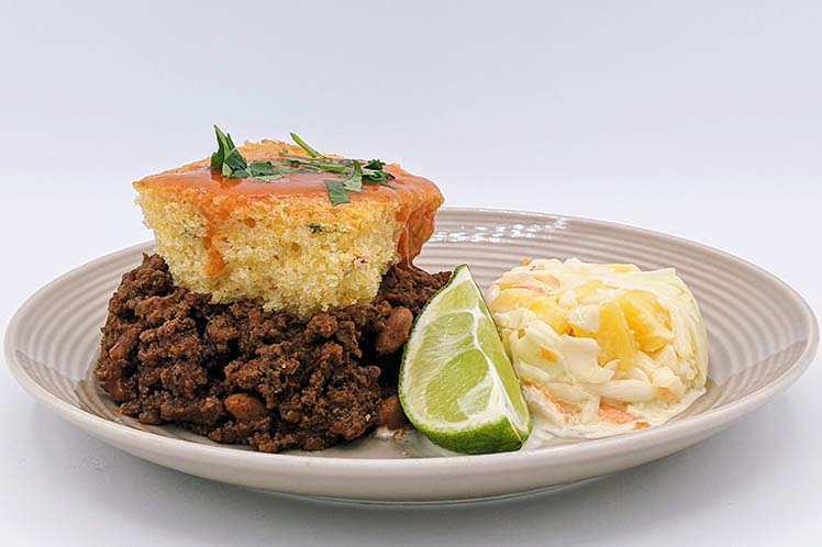 Beef tamale pie topped with cheddar cornbread, served with pineapple cole slaw.