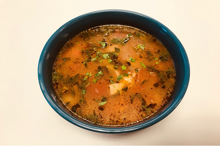 Bowl of vegetable minestrone soup with cannellini beans, vegetables and fresh basil.