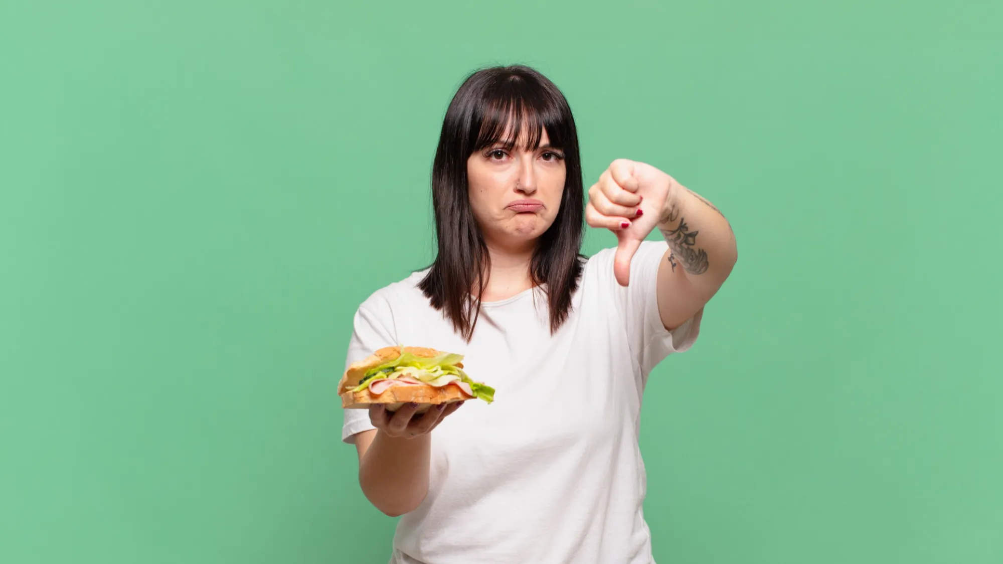 woman-thumbs-down-unhealthy-food-to-avoid-during-high-blood-pressure