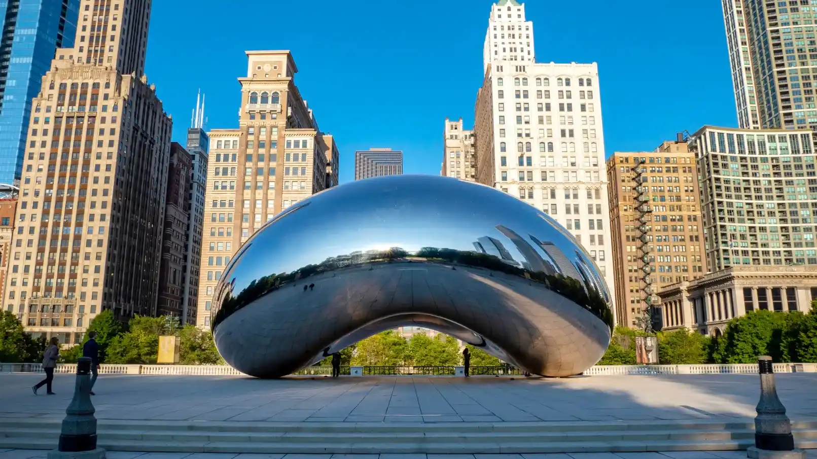 iconic Cloud Gate sculpture, known as The Bean, in Millennium Park, reflecting the Chicago skyline
